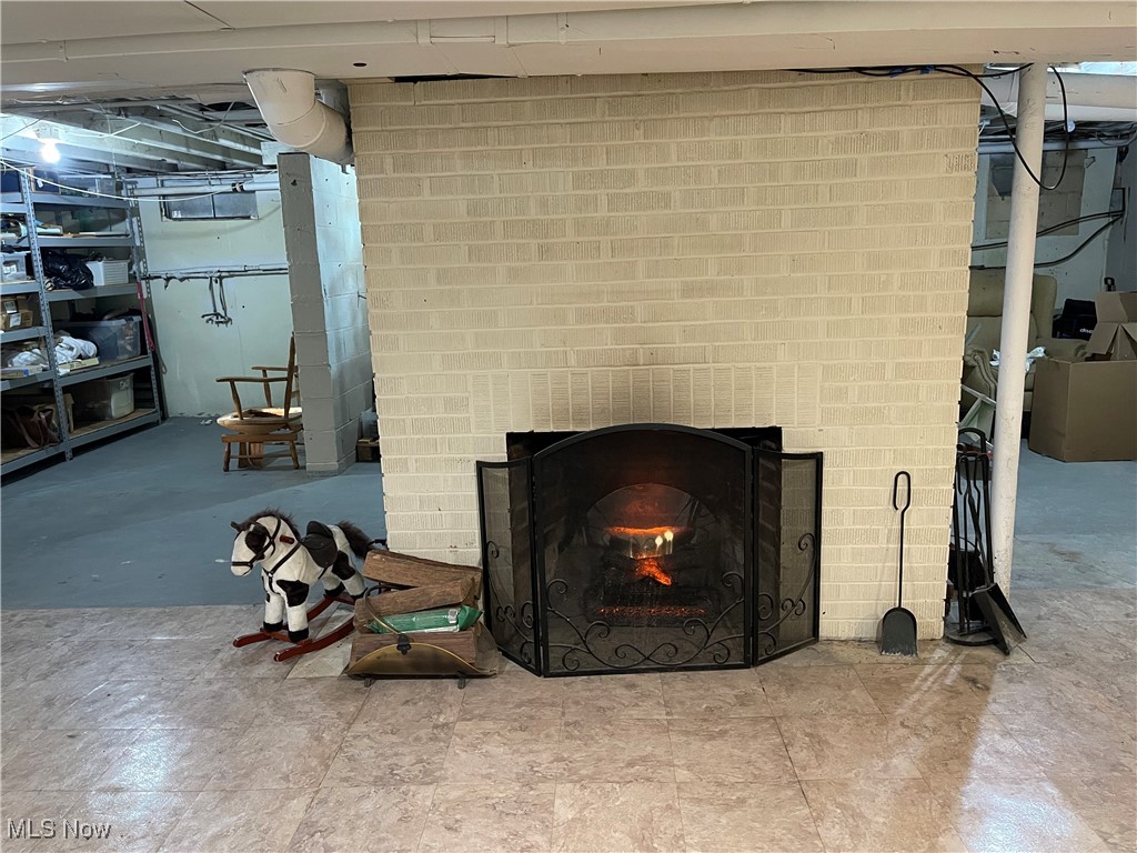 170 Burns Road Elyria, OH 44035 - Photo 26 of 32 Basement area with a brick fireplace electric insert