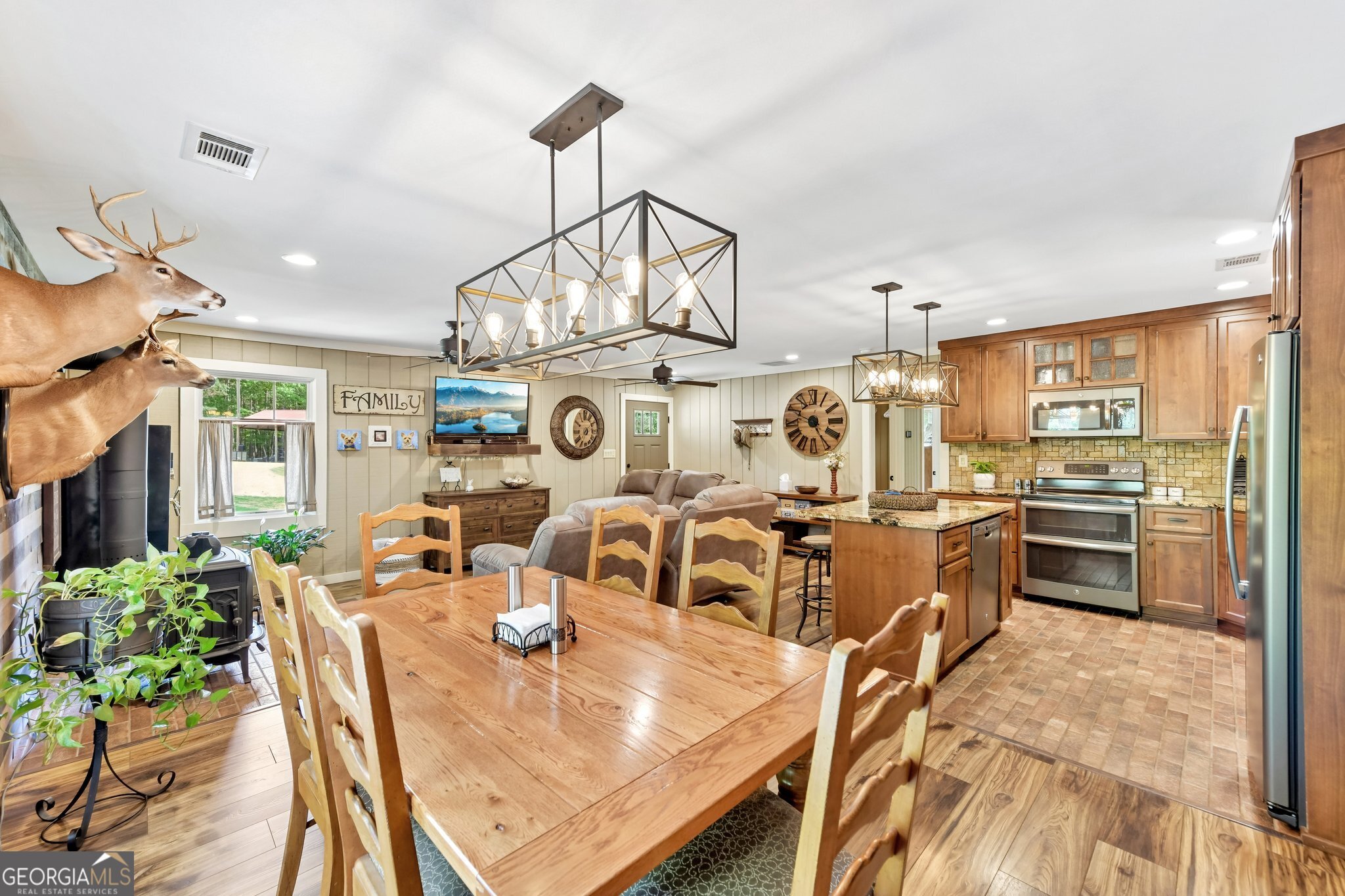 2630 Cold Springs Road Greensboro, GA 30642 - Photo 11 of 28 a view of a dining room and livingroom with furniture wooden floor a chandelier