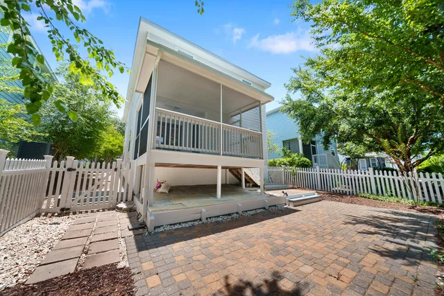 a wooden bench sitting in front of a house
