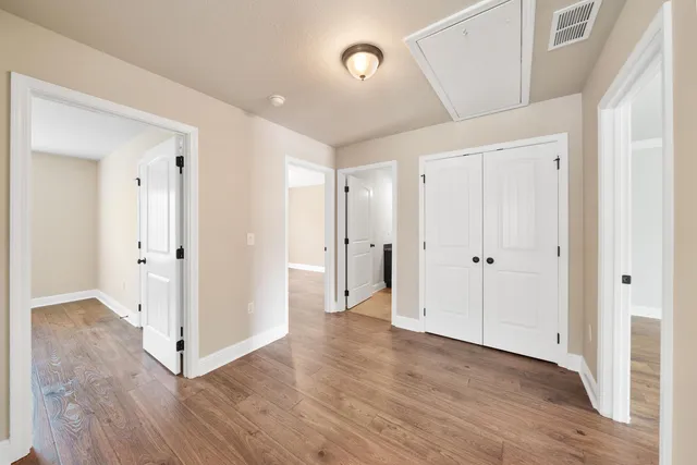 a view of an empty room with wooden floor