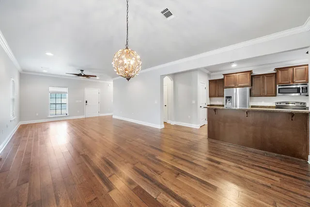 a view of wooden floor and windows in a room