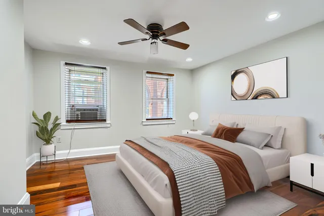 a bedroom with a large bed chandelier and a window