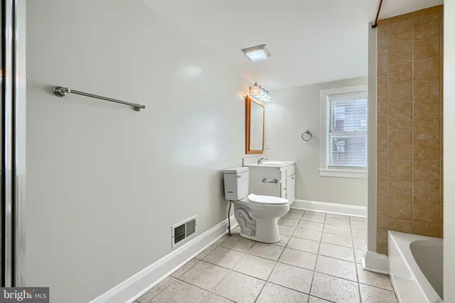 a bathroom with a toilet a sink and bathtub