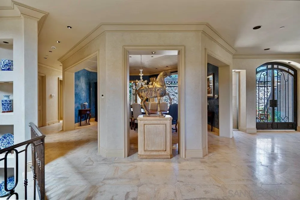 7756 St Andrews Road Rancho Santa Fe, CA 92067 - Photo 14 of 68 a view of a hallway with wooden floor and a living room