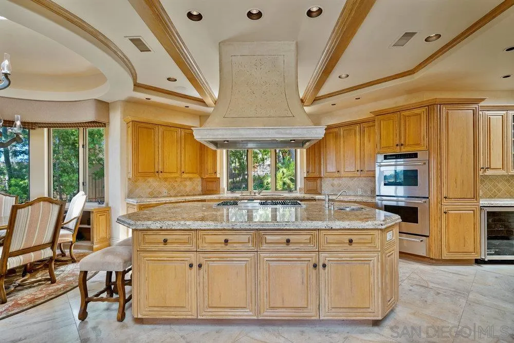 7756 St Andrews Road Rancho Santa Fe, CA 92067 - Photo 17 of 68 a kitchen with stainless steel appliances granite countertop a stove a chimney a sink and cabinets