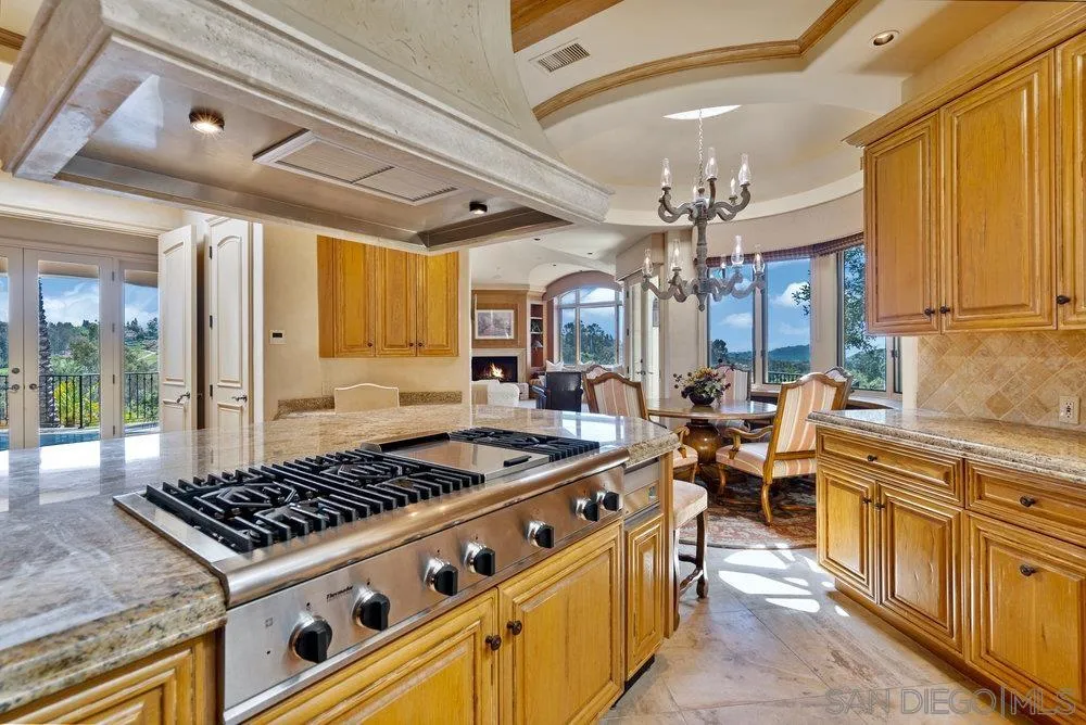 7756 St Andrews Road Rancho Santa Fe, CA 92067 - Photo 18 of 68 a kitchen with stove and cabinets