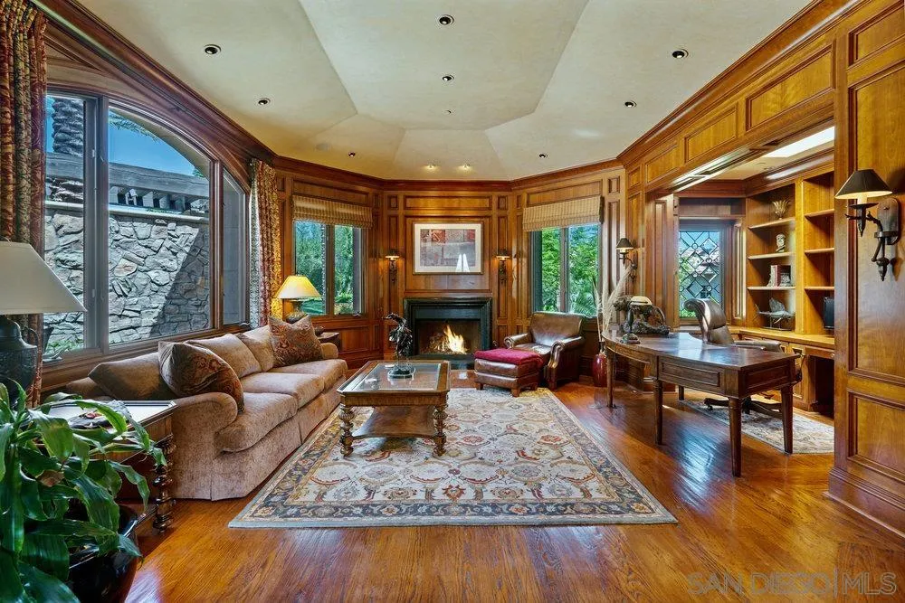 7756 St Andrews Road Rancho Santa Fe, CA 92067 - Photo 21 of 68 a living room with furniture fireplace and a large window