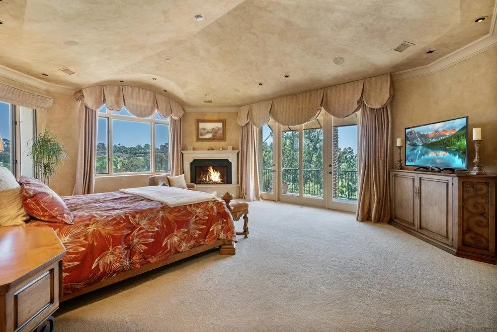 7756 St Andrews Road Rancho Santa Fe, CA 92067 - Photo 24 of 68 a bed room with a bed television and a large window