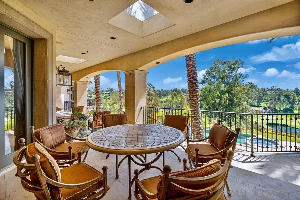 7756 St Andrews Road Rancho Santa Fe, CA 92067 - Photo 48 of 68 a view of a chairs and table in patio with a swimming pool