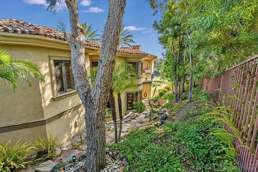 7756 St Andrews Road Rancho Santa Fe, CA 92067 - Photo 62 of 68 a view of a house with a small yard and plants