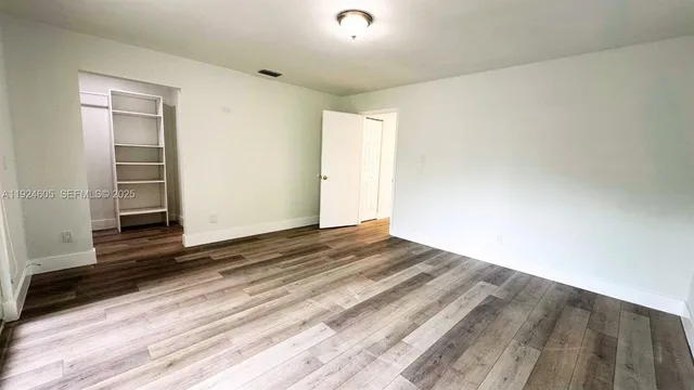 a view of a livingroom with wooden floor and closet