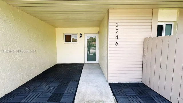 a view of a porch with wooden floor and a ceiling fan
