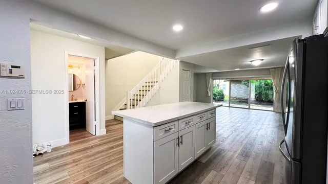 a kitchen with a stove and wooden floor
