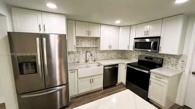 a kitchen with a refrigerator stove and microwave