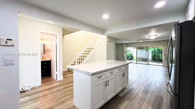 a kitchen with a stove and wooden floor