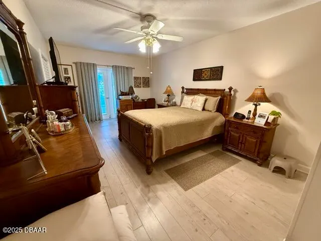 a bedroom with a bed flat screen tv and couches