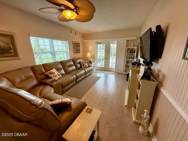 a living room with furniture a flat screen tv and a window