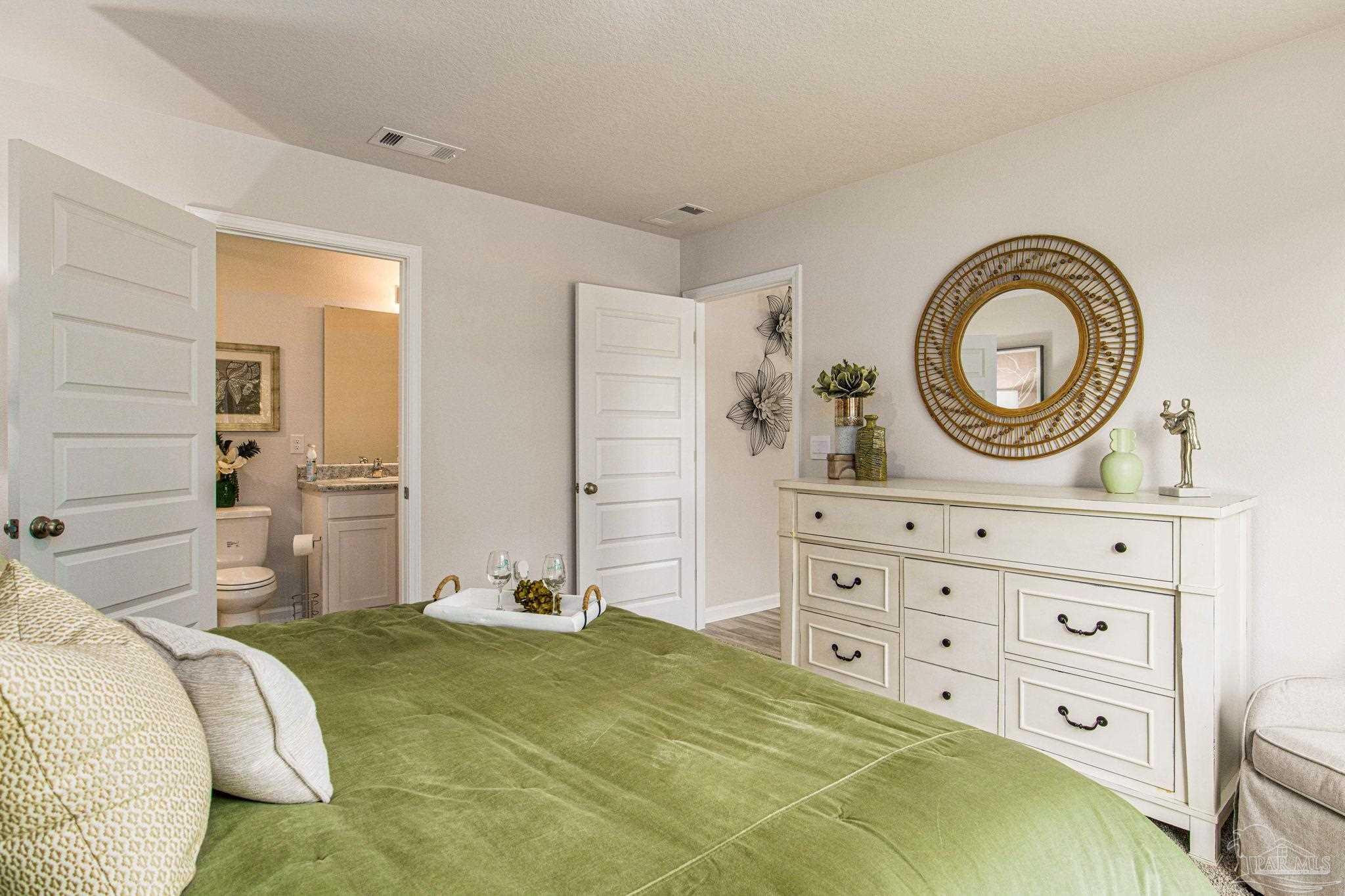 4413 White Birch Court Pace, FL 32571 - Photo 15 of 21 a bedroom with a bed and a dresser