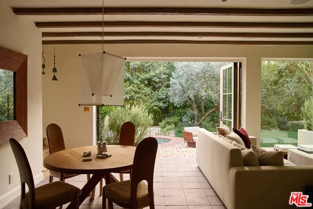 a dining room with furniture and a window