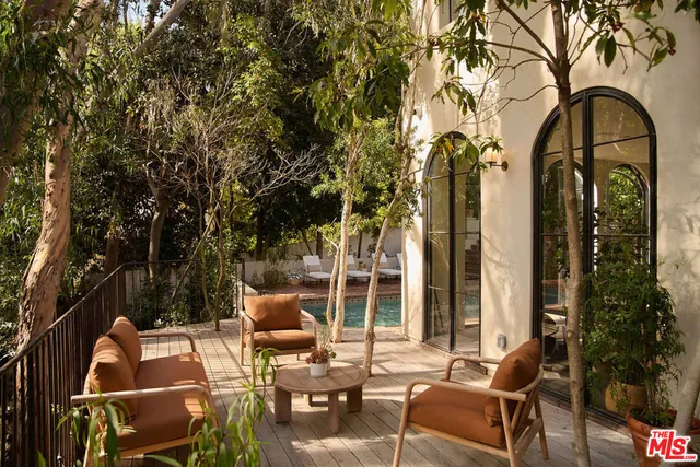 an outdoor space with patio the couches and a dining table with chairs