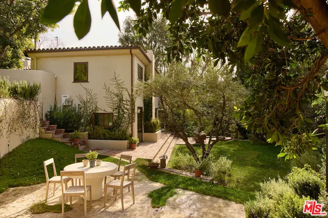 a view of a chairs and table in backyard