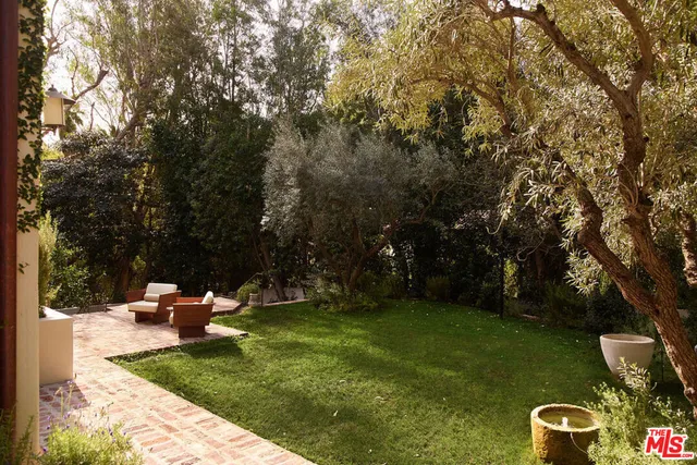 a backyard of a house with table and chairs