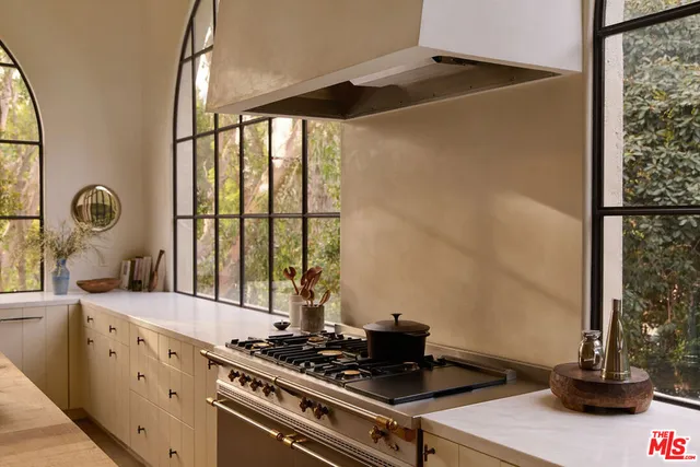 a kitchen with stainless steel appliances granite countertop a stove and a sink