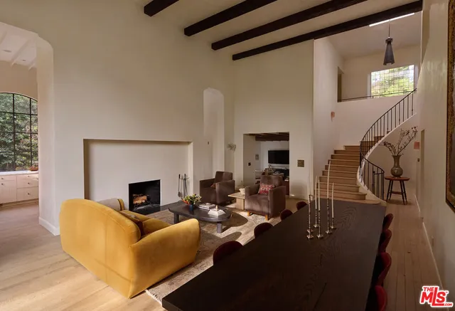a living room with furniture floor to ceiling window and fireplace