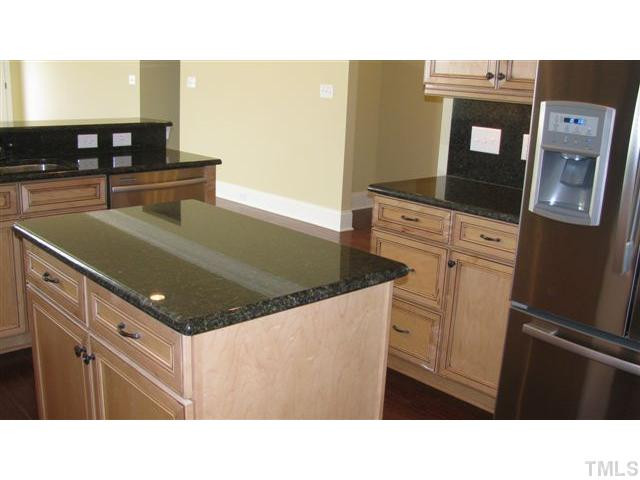 10115 2nd Star Court Raleigh, NC 27613 - Photo 9 of 25 Here's a Kitchen that has every convenience imaginable: 42" upscale cabinets, island storage, a bank of drawers, under-cabinet lighting, pull-out trashcan, double stainless steel sink, granite counter tops, display space above the upper cabinets...WOW! Kitchen