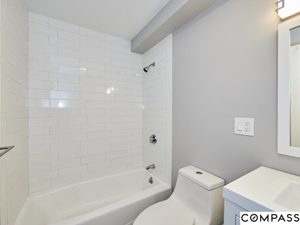 145 Pearl Street, Unit 145 Cambridge, MA 02139 - Photo 11 of 26 a white toilet sitting next to a bath tub