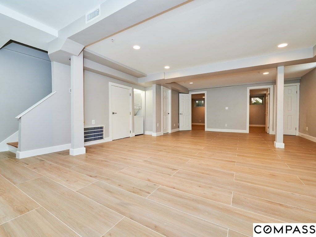 145 Pearl Street, Unit 145 Cambridge, MA 02139 - Photo 16 of 26 a view of an empty room with wooden floor
