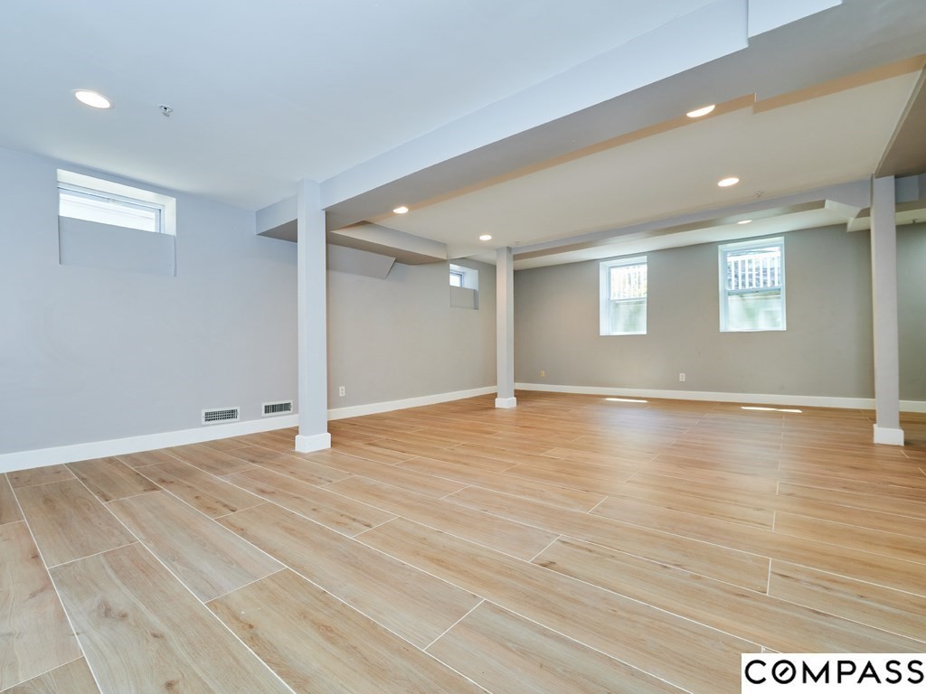 145 Pearl Street, Unit 145 Cambridge, MA 02139 - Photo 17 of 26 a view of empty room with wooden floor and fan
