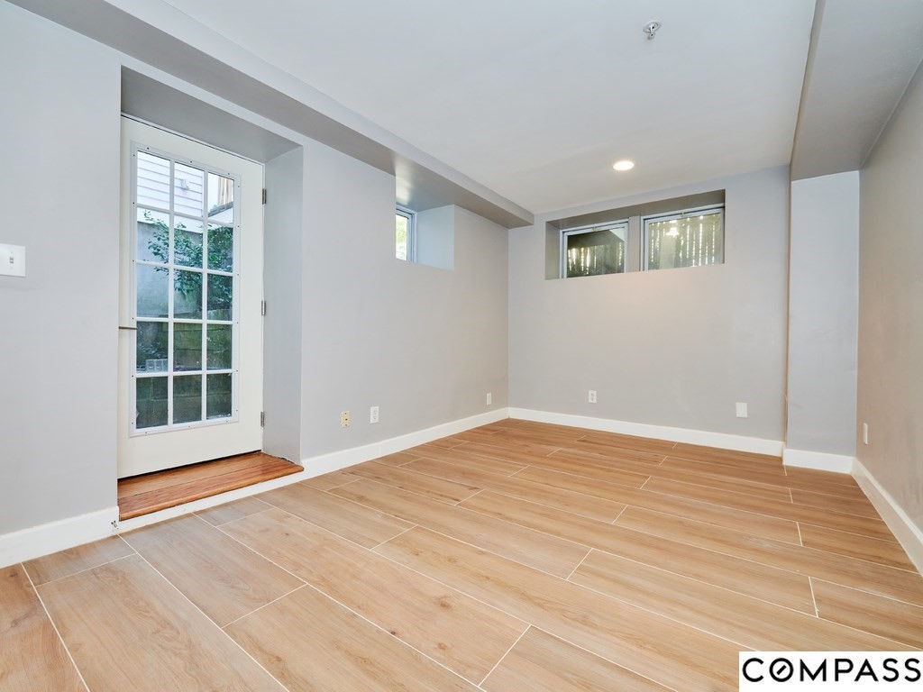 145 Pearl Street, Unit 145 Cambridge, MA 02139 - Photo 19 of 26 a view of an empty room with a window