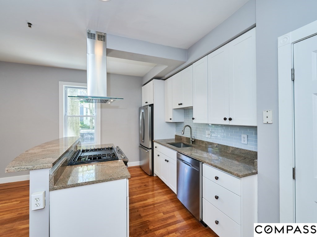 145 Pearl Street, Unit 145 Cambridge, MA 02139 - Photo 3 of 26 a kitchen with granite countertop a sink stainless steel appliances and cabinets