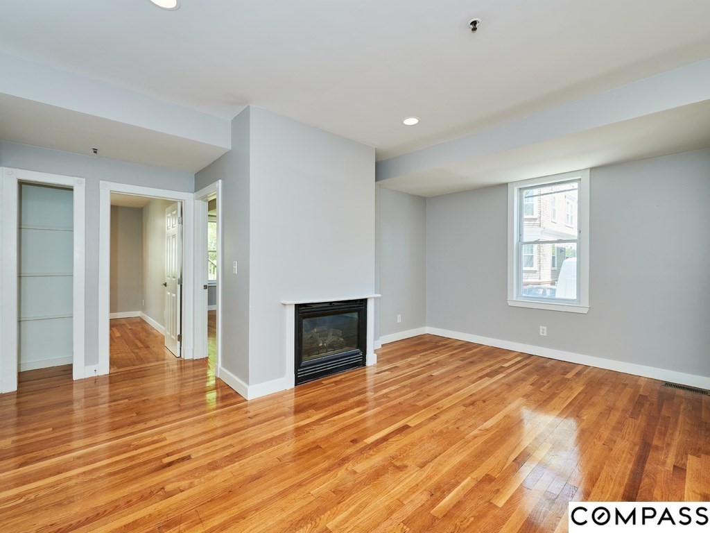 145 Pearl Street, Unit 145 Cambridge, MA 02139 - Photo 6 of 26 a view of empty room with wooden floor