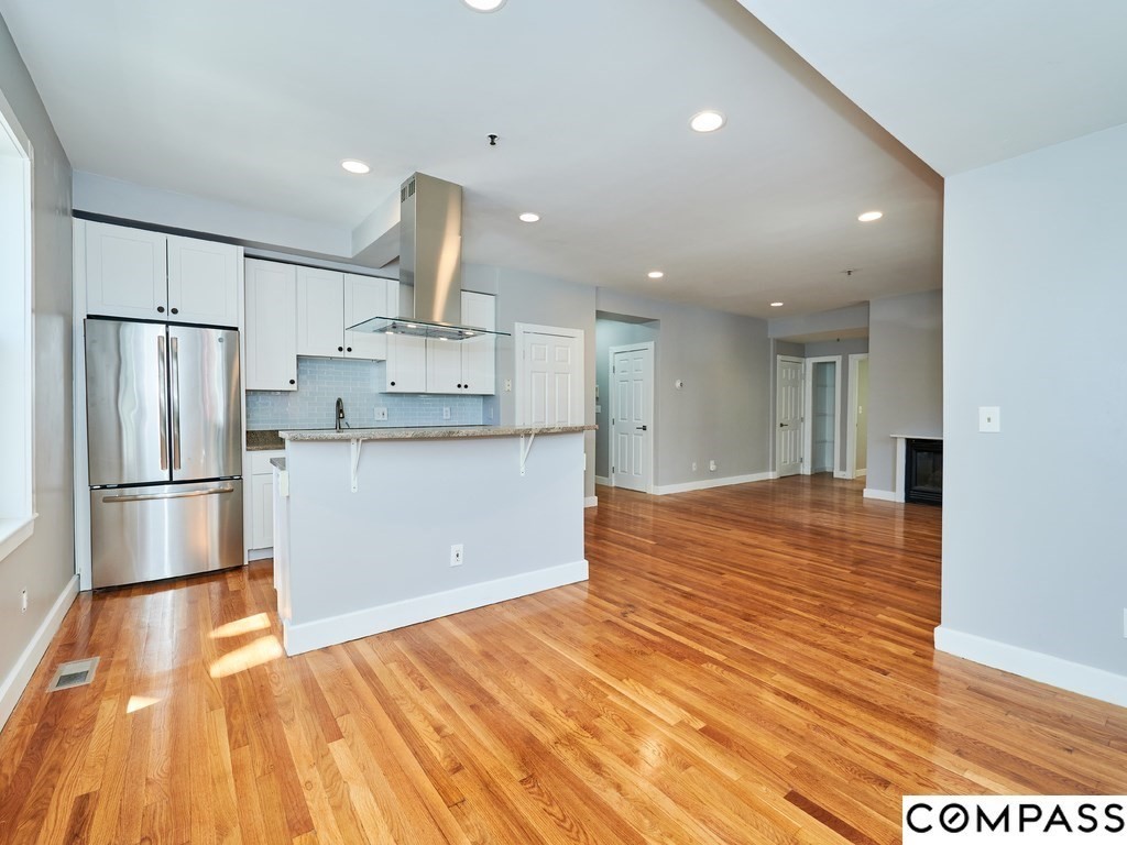145 Pearl Street, Unit 145 Cambridge, MA 02139 - Photo 8 of 26 a large kitchen with stainless steel appliances a refrigerator and a stove top oven