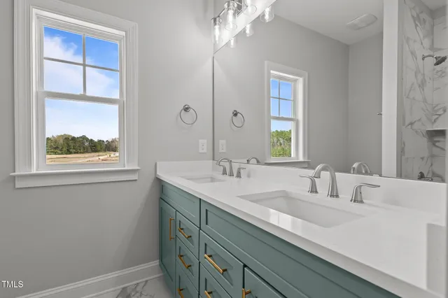 an empty room with a window and a ceiling fan