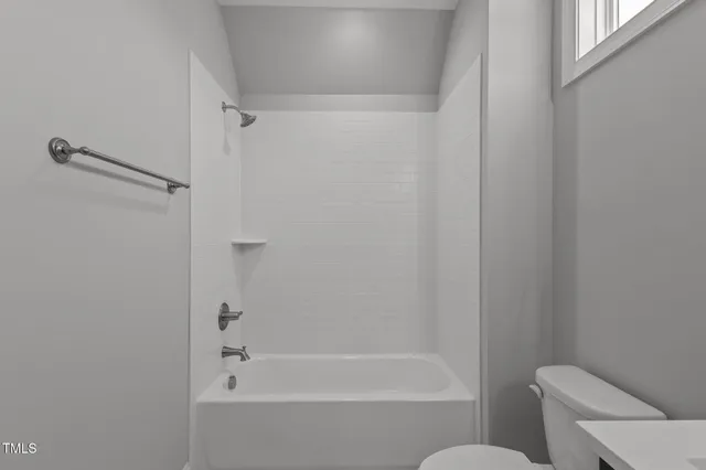 a bathroom with a double vanity sink toilet and a bathtub