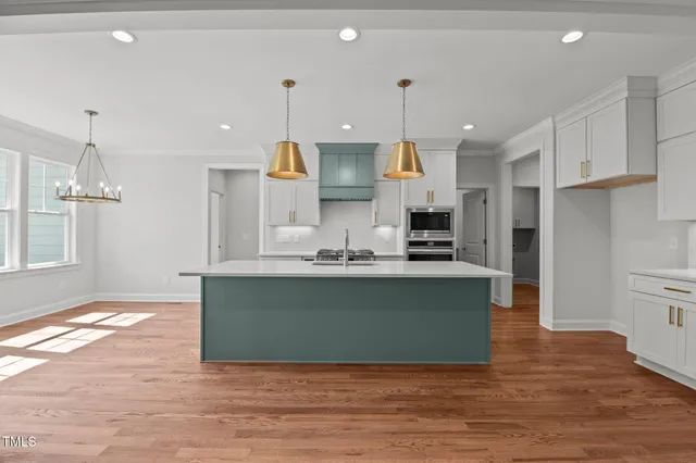 a kitchen with a sink a counter space and stainless steel appliances
