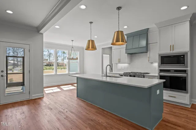 a view of storage and utility room with wooden floor