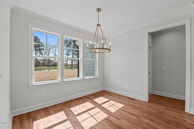 a kitchen with stainless steel appliances granite countertop a sink a stove and a wooden floors