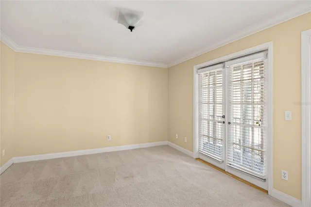 a view of an empty room with glass door