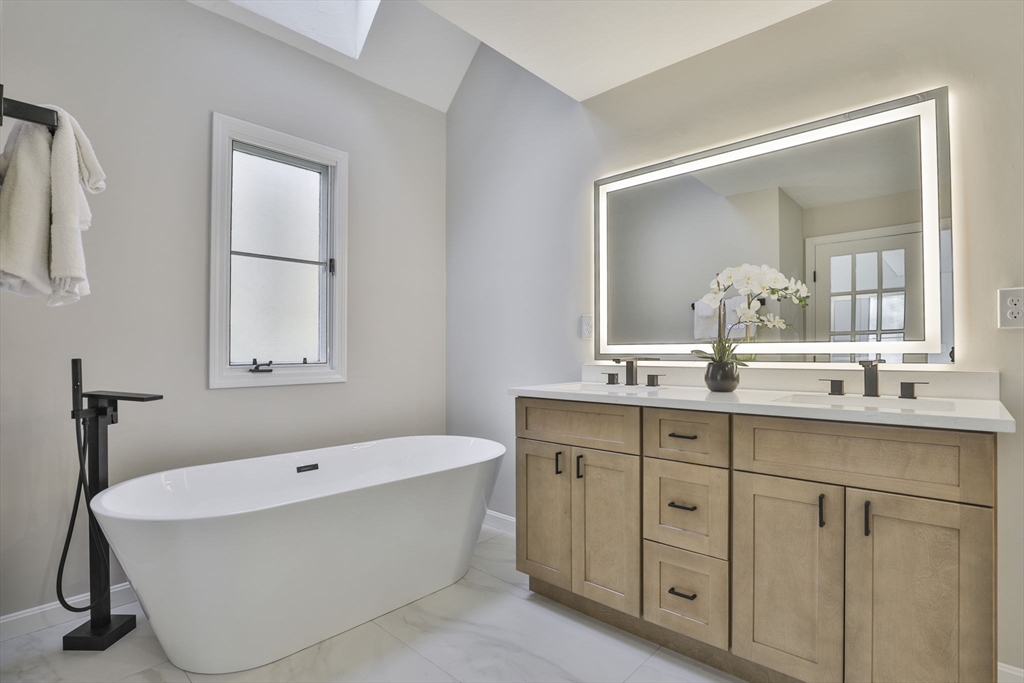 72 Ayer Road Harvard, MA 01451 - Photo 24 of 38 a bathroom with a tub a sink and mirror