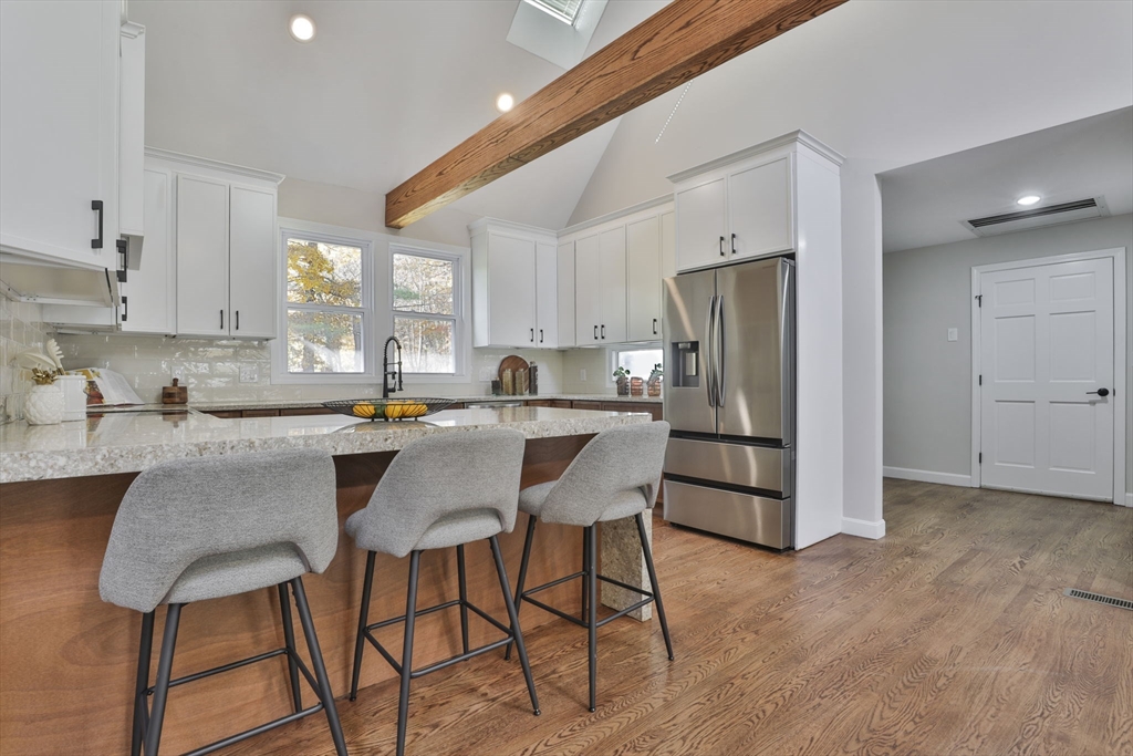 72 Ayer Road Harvard, MA 01451 - Photo 8 of 38 a kitchen with stainless steel appliances granite countertop a dining table chairs refrigerator and sink