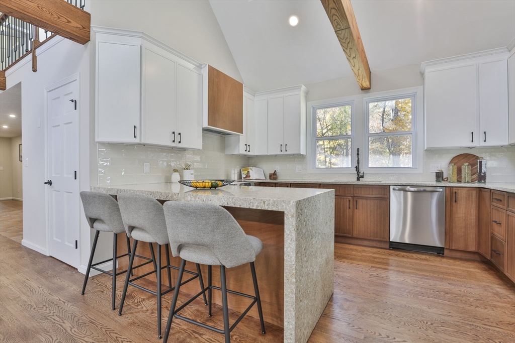 72 Ayer Road Harvard, MA 01451 - Photo 9 of 38 a kitchen with stainless steel appliances granite countertop a table chairs sink and cabinets