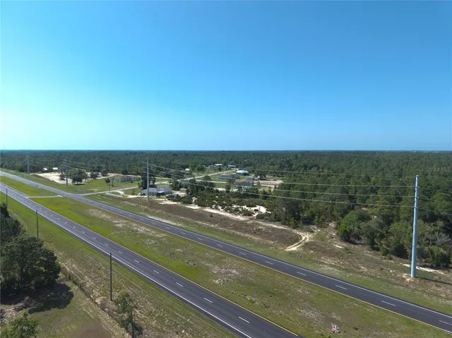 a view of a city street with a ocean view