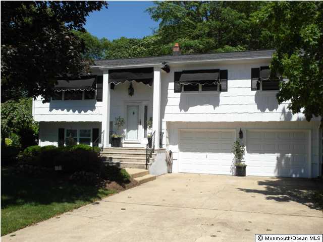 7 Branch Road Oakhurst, NJ 07755 - Photo 1 of 3 a front view of a house with street