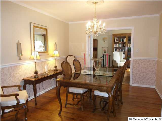 7 Branch Road Oakhurst, NJ 07755 - Photo 3 of 3 a dining room with furniture a chandelier and wooden floor