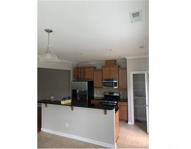 a kitchen with a sink cabinets and appliances