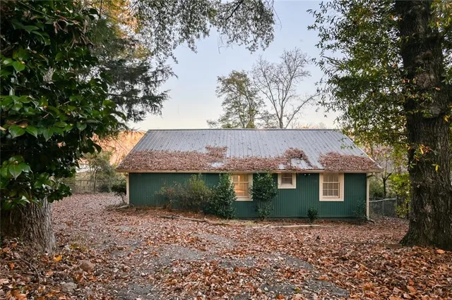 a view of a house with a yard patio and a trees